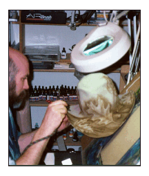 Tim airbrush painting with dyes on a cowboyhat